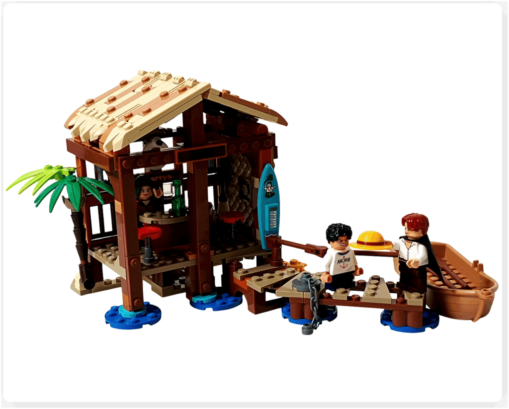 レゴ ONE PIECE 75636「フーシャ村」の名シーン再現。桟橋でシャンクスが麦わら帽子をルフィに差し出す姿が描かれ、物語の原点を象徴する感動的なハイライトとして表現された情景。