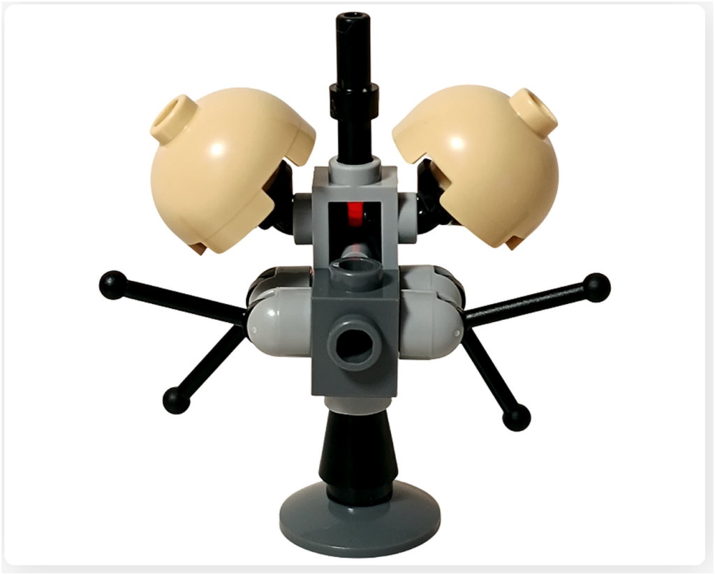 LEGO スター・ウォーズ 75418 アドベントカレンダー2025に収録されたバズ・ドロイドを背面から撮影した写真。中央のグレー支柱を軸に、左右へ伸びる黒いアームと下部スタンドが確認でき、前面の半球パーツを支える構造が分かる。