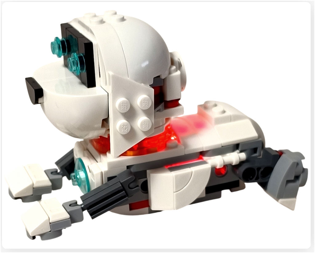 レゴ 31164 うちゅうロボット 「うちゅう犬」が寝そべった状態で胸のコアを赤く発光させている様子。白とグレーの機体が静かな室内でやわらかく光っているシーン。